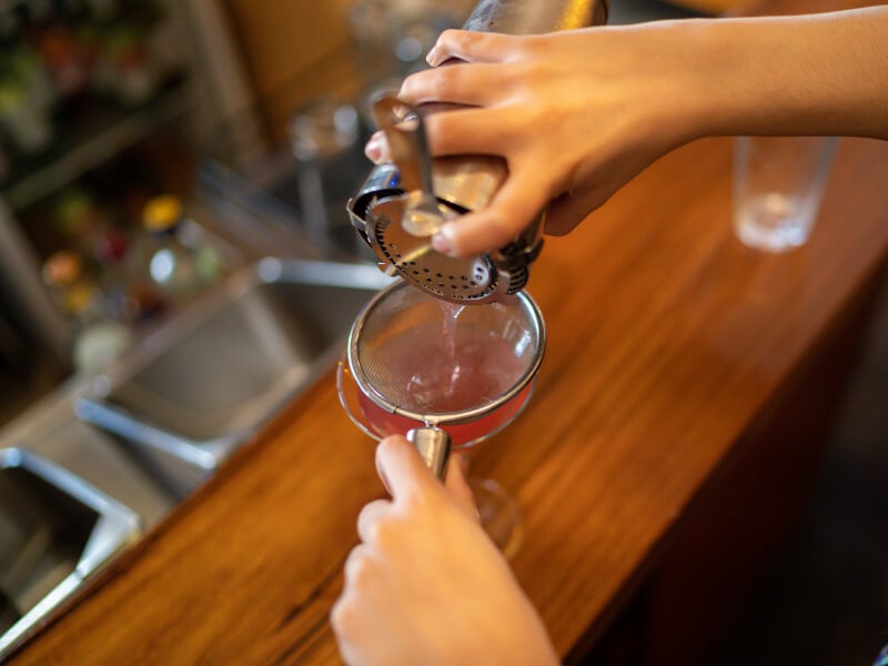 pouring cocktail into glass